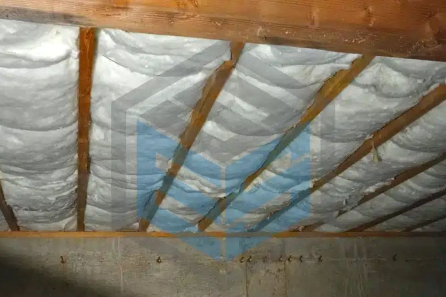 Insulation material spread across the attic floor of a house, providing thermal protection and energy efficiency.